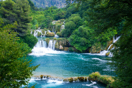 Beautiful river waterfalls among green plants, trees and forests In Krka National Park, Dalmatia, Croatia, Europeの写真素材