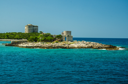 Monastery and church Vavedenja Presvete Bogorodice on island Mala Gospa and fortress Arza near Zanjic on Lustica peninsula, Boka Kotor bay with blue turquoise paradise water, Montenegroのeditorial素材