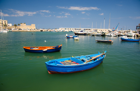 Colourful fishing boats in harbour of the city of Bari, Puglia Apulia region, Southern Italy