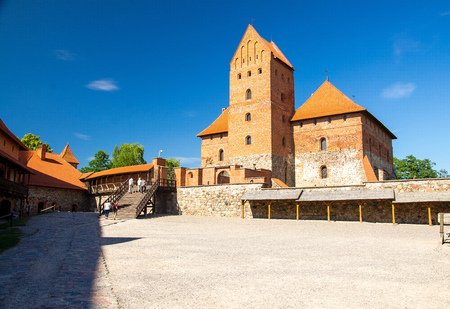 Courtyard of medieval gothic Trakai Island Castle with stone walls and towers with red tiled roofs...