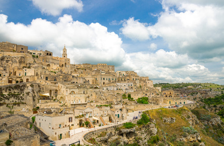Matera panoramic view of historical centre Sasso Caveoso Sassi old ancient town with rock houses with blue sky white clouds, European Culture Capital, UNESCO World Heritage, Basilicata, Southern Italyの写真素材