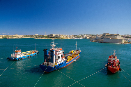 Three colourful cargo ships in the harbour of Valletta view from upper Barrakka gardens, Maltaの写真素材
