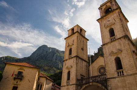 Church Cathedral of Saint Tryphon in the old town of Kotor in front of Lovcen mountains and blue sky, Montenegroの写真素材