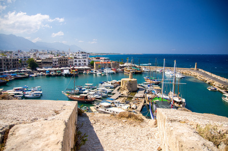Panoramic view from old castle of marina harbour and port with yachts in Kyrenia Girne town against blue sky and mountains, North Cyprusの写真素材