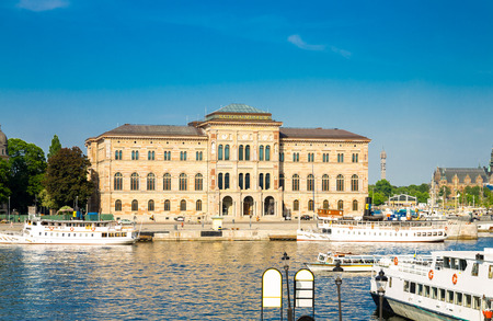 National Museum of Fine Arts (Nationalmuseum) building located on peninsula Blasieholmen in city centre with white boats, ships on Lake Malaren water, blue sky background, Stockholm, Swedenのeditorial素材