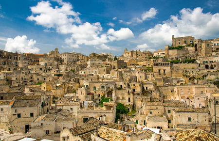 Matera panoramic view of historical centre Sasso Caveoso Sassi old ancient town with rock houses with blue sky white clouds, European Culture Capital, Basilicata, Southern Italyの写真素材