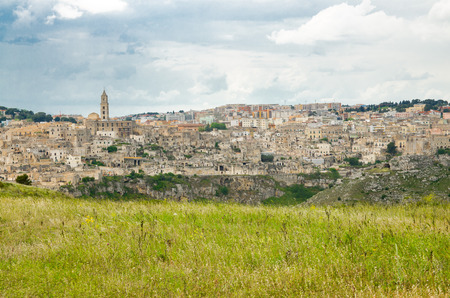 Matera panoramic view of historical centre Sasso Caveoso old ancient town Sassi di Matera with cave rock houses with dramatic sky, view from Murgia Timone, Basilicata, Southern Italyの写真素材
