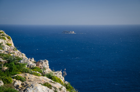 View of limestone rock, Mediterranean sea and the island of Filfla from Dingli Cliffs, Maltaの写真素材
