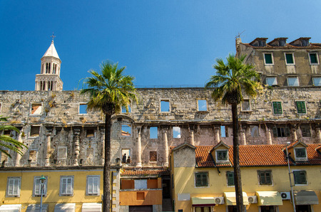 Tall venetian Saint Domnius bell tower and Riva wall palm waterfront view, Split, Dalmatia, Croatiaの写真素材