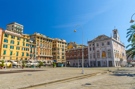 Row of colorful buildings and Palazzo San Giorgio palace on Piazza Caricamento square near harbor in historical centre of old european city Genoa Genova with blue sky background, Liguria, Italyの写真素材