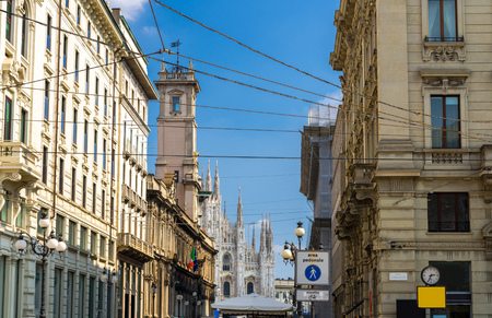 Duomo di Milano cathedral on Piazza del Duomo square and Palazzo Giureconsulti palace with clock tower on Piazza Mercanti pedestrian street in Milan historical city centre, Lombardy, Italyのeditorial素材