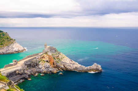 Chiesa San Pietro catholic church, Lord Byron Parque Natural park De Portovenere town on stone cliff rock, turquoise water of Ligurian sea and blue sky, Riviera di Levante, La Spezia, Liguria, Italyの写真素材