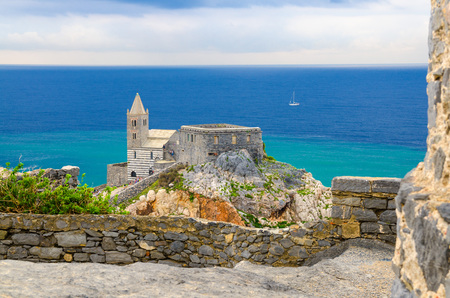 Chiesa San Pietro church, Lord Byron Parque Natural park De Portovenere town on stone cliff rock and blue sky, view from Doria castle, Ligurian sea, Riviera di Levante, La Spezia, Liguria, Italyのeditorial素材