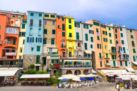 Row of colorful multicolored buildings houses and restaurants of Portovenere coastal town village in harbor of Ligurian sea, Riviera di Levante, National park Cinque Terre, La Spezia, Liguria, Italyの写真素材