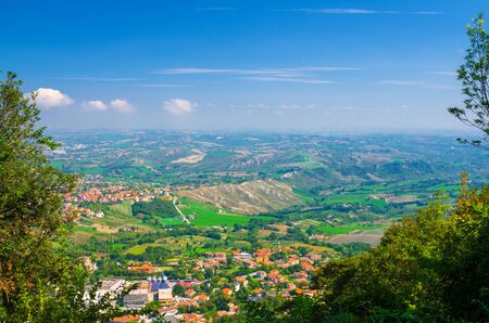 Aerial top panoramic view of landscape with valley, green hills, fields and villages of Republic San...