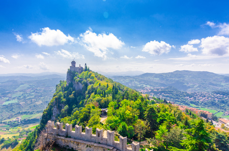 Republic San Marino Seconda Torre La Cesta second fortress tower with brick walls on Mount Titano stone rock, green trees, aerial top panoramic view of landscape valley and hills of suburban districtのeditorial素材