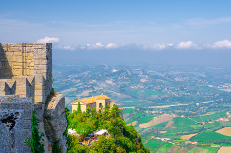 Aerial top panoramic view of Basilica Pieve, Palazzo Pubblico palace and landscape with valley, green hills, fields and villages of Republic San Marino suburban district, View from San Marino fortressのeditorial素材