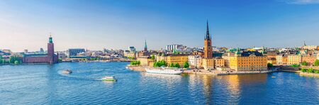 Aerial scenic panoramic view of Stockholm skyline with Old town Gamla Stan, City Hall Stadshuset, Riddarholmen island with gothic Church building and boat ship sailing on water of Lake Malaren, Swedenの写真素材