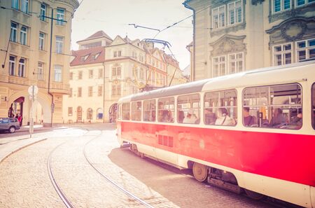 Typical old retro vintage tram on tracks near tram stop in the streets of Prague city in Lesser Town (Mala Strana) district, Bohemia, Czech Republic. Public transport concept.の写真素材