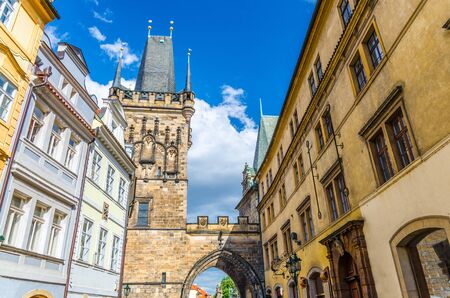 Prague Mala Strana Bridge Tower Malostranska vez on Charles Bridge Karluv Most over Vltava river in historical city centre Lesser Town, blue sky white clouds background, Bohemia, Czech Republicの写真素材