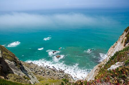 Portugal, Cabo da Roca, The Western Cape Roca of Europe, white clouds over the Atlantic ocean, ocean view from the Cape  Roca, cliff above the Atlantic ocean, azure water in the Atlanticaの写真素材