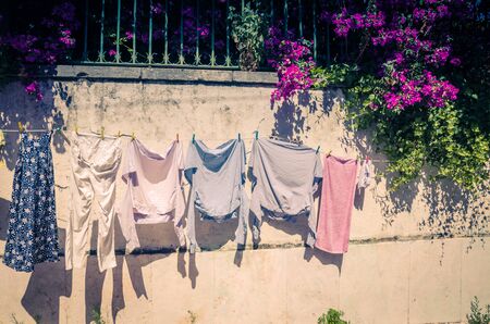 Portugal, Lisbon in June, street character, drying clothes on a clothesline, street with clothes hanging, pink bush on the street of Lisbonの写真素材