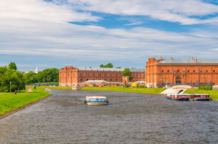 Tourist boat on Kronverksky Strait channel and The Military Historical Museum of Artillery, Engineers and Signal Corps in Kronverk of Peter and Paul Fortress, Saint Petersburg Leningrad city, Russiaのeditorial素材