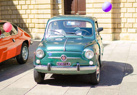 Lecce, Italy - April 23, 2016: Front view of vintage classic retro green automobile car parked in a...