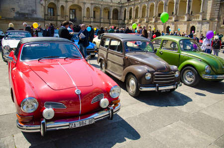 Lecce, Italy - April 23, 2017: Row of colourful vintage classic retro automobiles cars with color baloons parked at the central square Piazza del Duomo during exhibition, Puglia Apulia region, Southern Italyのeditorial素材