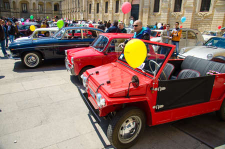 Lecce, Italy - April 23, 2017: Row of colourful vintage classic retro automobiles cars with color baloons parked at the central square Piazza del Duomo during exhibition, Puglia Apulia region, Southern Italyのeditorial素材