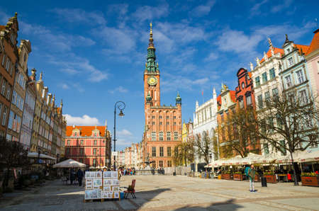 Gdansk, Poland, April 17, 2018: City Hall with spire, clock tower and Facade of beautiful typical colorful houses buildings at Dluga Long Market street Dlugi targ square in old historical town centreのeditorial素材