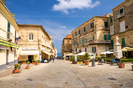 Tropea, Italy - May 9, 2018: Streets of town with cafes and restaurants, buildings with balconies and shutter windows, blue sky with clouds on backgrond, Calabriaのeditorial素材