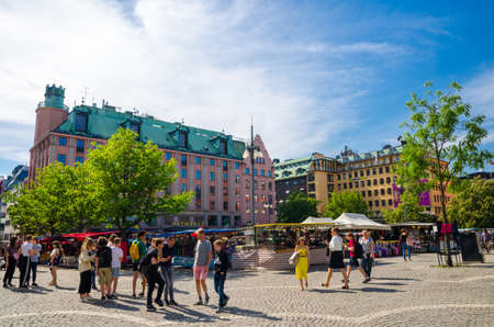 Sweden, Stockholm, May 29, 2018: Young people play, walking and spend time at Hotorget Square near Haymarket Scandic Hotel in city centre in beautiful clear summer dayのeditorial素材