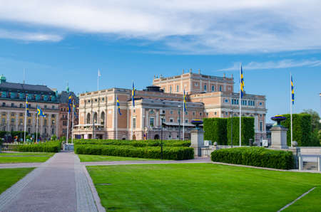 Sweden, Stockholm, May 29, 2018: The Royal Swedish Opera house (Kungliga Operan) building with green bushes and grass lawn foreground in clear summer day in historical centre of Stockholm, Swedenのeditorial素材