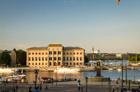 Sweden, Stockholm, May 29, 2018: National Museum of Fine Arts Nationalmuseum building on peninsula Blasieholmen and Gustav monument in city centre with blue sky view from old town quarter Gamla Stanのeditorial素材