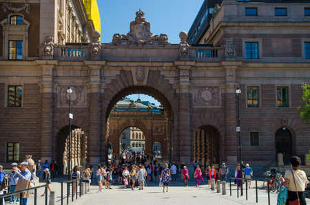 Sweden, Stockholm, May 31, 2018: People walk through Courtyard between arches of Parliament House Riksdag (Riksdagshuset) buildings, Stockholm, Swedenのeditorial素材