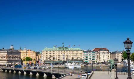 Sweden, Stockholm, May 31, 2018: aerial panoramic view of bridge, street lights lamp, lion statue monument, Lake Malaren harbour embankment with typical Swedish buildings and hotel with copy spaceのeditorial素材