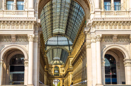 Milan, Italy, September 9, 2018: Gallery Vittorio Emanuele II Galleria famous luxury shopping mall facade and interiorÐ± fashion stores, glass dome and lamps in Milan city centre on Piazza del Duomoのeditorial素材