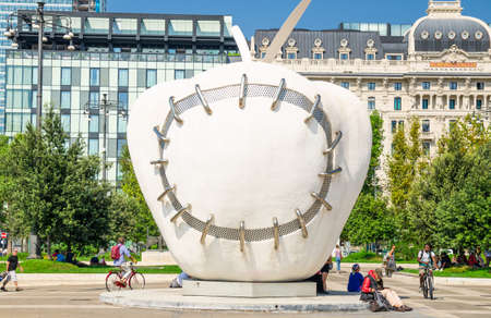 Milan, Italy, September 9, 2018: Reintegrated Apple sculpture by Michelangelo Pistoletto on Piazza Duca d'Aosta square near Milano Centrale stazione railway central train station buildingのeditorial素材