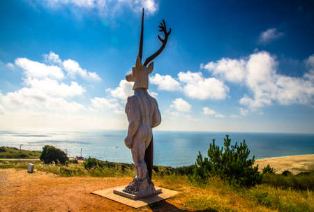 Nazare, Portugal - June 24, 2017: The Legend of Nazare statue monument view of the Atlantic ocean