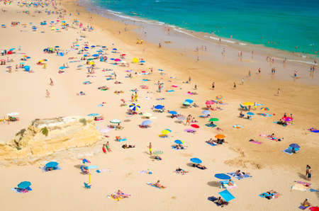 Portimao, Algarve, Portugal, June 19, 2017: Praia de Rocha beach with tourists and colourful umbrellasのeditorial素材
