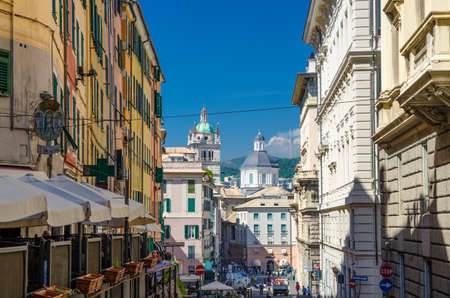 Genoa, Italy, September 11, 2018: Buildings with colorful walls and dome of San Lorenzo Cathedral catholic church background in historical centre of old european city Genova, Liguriaのeditorial素材