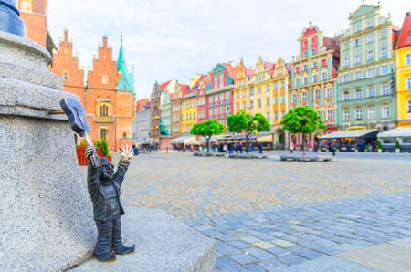 Wroclaw, Poland, May 7, 2019: Dwarf with guitar on Rynek Market Square, typical colorful buildings, famous bronze miniature gnome with hat sculpture is a symbol of Wroclaw, old historical city centreのeditorial素材
