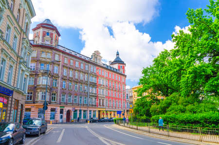 Wroclaw, Poland, May 7, 2019: Street of city with multistory buildings near plac Square St. Matthias park with green trees, blue sky backgroundのeditorial素材
