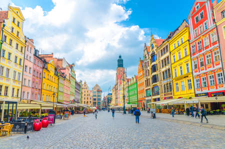 Wroclaw, Poland, May 7, 2019: old town historical city centre, colorful buildings with multicolored facade, St. Elizabeth Minor Basilica Garrison catholic Church on cobblestone Rynek Market Squareのeditorial素材
