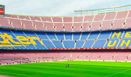 Barcelona, Spain, March 14, 2019: Camp Nou is the home stadium of football club Barcelona, the largest stadium in Spain. View of tribunes stands, green grass field and scoreboard from reserves bench.のeditorial素材