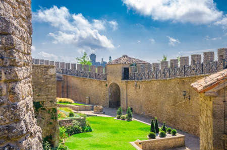 Republic San Marino, September 18, 2018: Stone brick fortress wall with merlons and courtyard of Prima Torre Guaita first tower and Seconda Torre La Cesta on Mount Titano rock with blue skyのeditorial素材