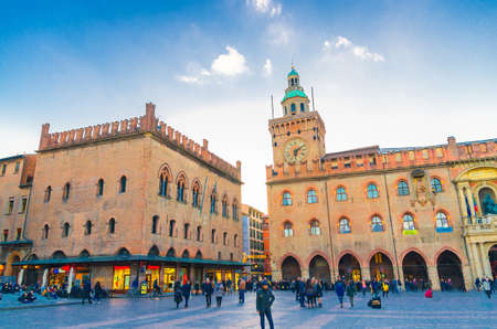 Bologna, Italy, March 17, 2019: Palazzo dAccursio (Palazzo Comunale) palace building on Piazza Maggiore square and many walking people tourists in old historical city center, Emilia-Romagnaのeditorial素材