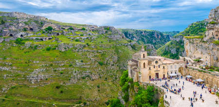 Matera, Italy, May 6, 2018: Aerial panoramic view of historical centre old ancient town Sassi and caves di Murgia Timone near canyon, Church Chiesa San Pietro Caveoso on square, Basilicataのeditorial素材
