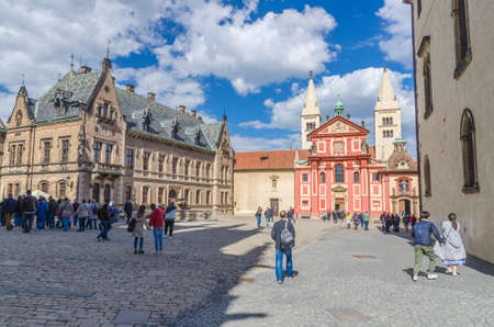 Prague, Czech Republic, May 13, 2019: courtyard square with St. George's Basilica towers of the Prague Castle buildings, walking people tourists, Mala Strana Lesser Town, Bohemiaのeditorial素材
